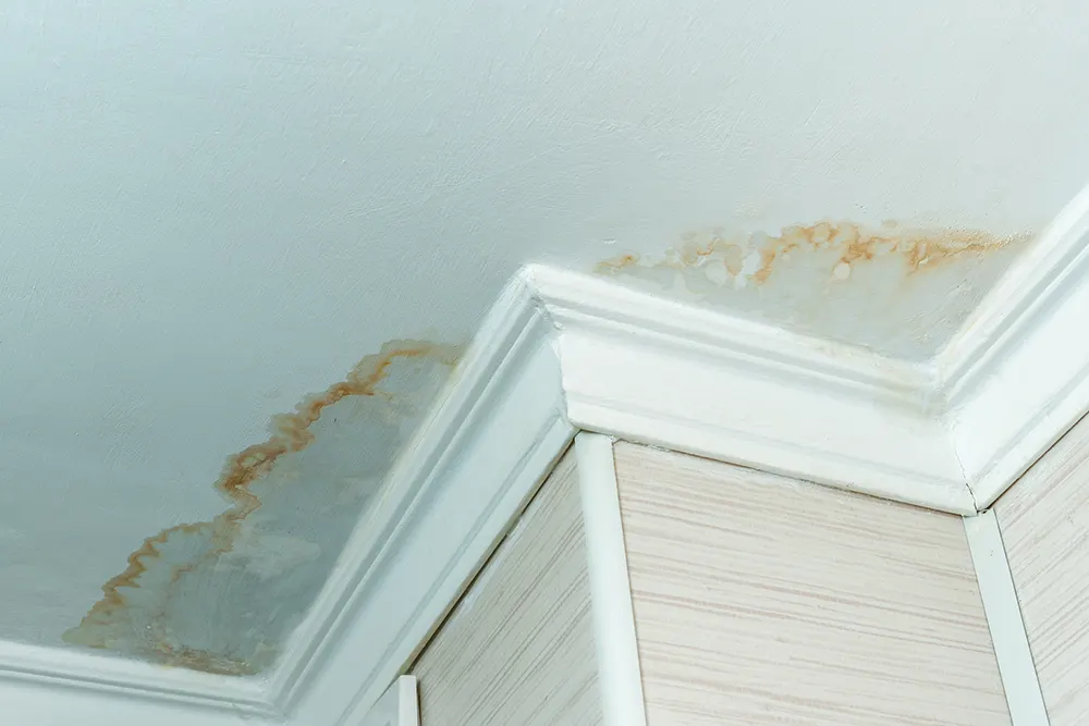 image of a home's ceiling with water damage from a leaking toilet